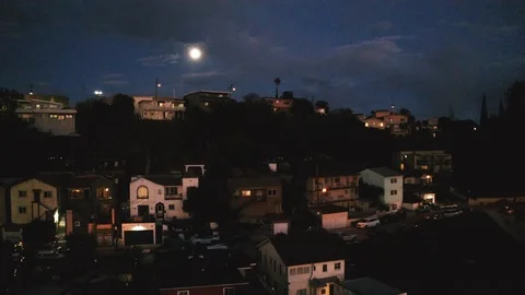 Camera dollies past a row of Hollywood Hills Homes at night Stock Footage
