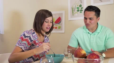 Camera dollies as young couple eats dinner Video stock 64330983