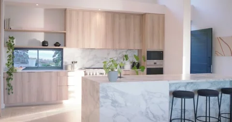 Camera is dollying and panning through modern kitchen, highlighting marble Stock Footage 337730086