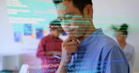 Camera dollying panning tech office showing coder scrolling tablet with code Stock Footage 325706542