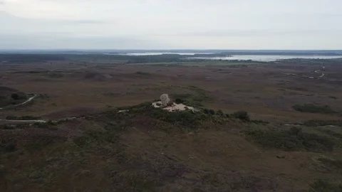 Camera done flies towards giant boulder on a heath - Agglestone Rock Stock Footage 146879262