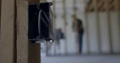 Camera drifts past wires in junction box as contractors work on house 4K Stock Footage 80727197