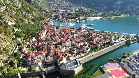 A camera drone ascends above Kotor Old Town Stock Footage 249421353