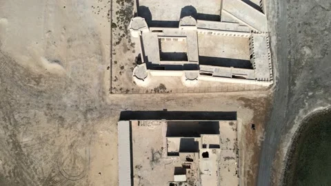 A camera drone fies forward over Aqeer (Al Uqayr) Castle, Saudi Arabia Stock Footage 220083837