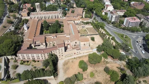 A camera drone flies ahead above the Monastery of Pedralbes Stock Footage 202594437