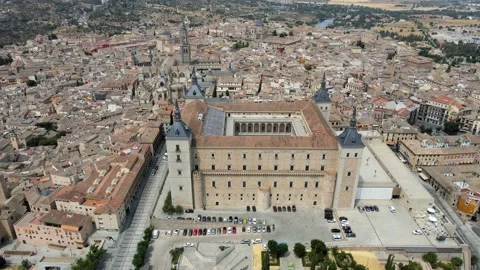 A camera drone flies ahead over the old town and the Alcázar of Toledo Stock Footage 202073051
