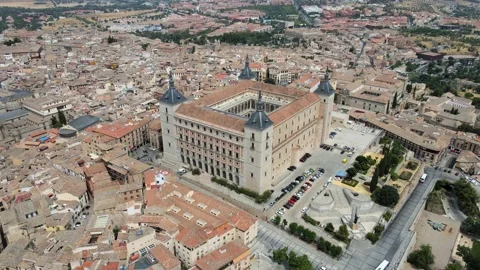A camera drone flies ahead over the old town and the Alcázar of Toledo Stock Footage 202073186