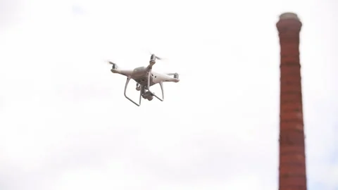 Camera drone flies in the air on the territory of the plant Stock Footage 201148158