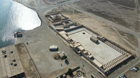 A camera drone flies around Aqeer (Al Uqayr) Castle Stock Footage 220083983