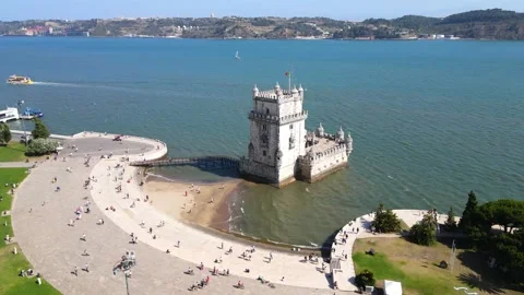 A camera drone flies around the Belem Tower Stock Footage 202012738