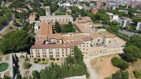A camera drone flies around the Monastery of Pedralbes Stock Footage 202597516