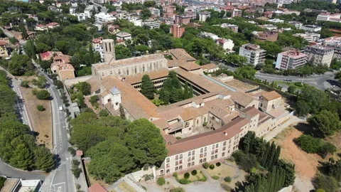 A camera drone flies around the Monastery of Pedralbes Stock Footage 202600234