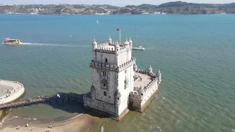 A camera drone flies away from the Belem Tower Stock Footage 202012795