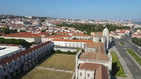 A camera drone flies backward above the Jerónimos Monastery and Maritime Museum Stock Footage 202012626