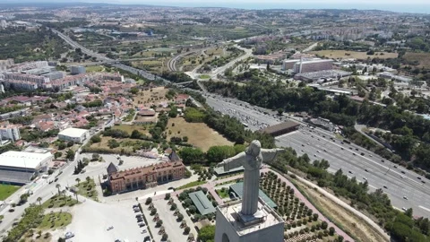 A camera drone flies backward above the Sanctuary of Christ the King in Lisbon Stock Footage 202016219