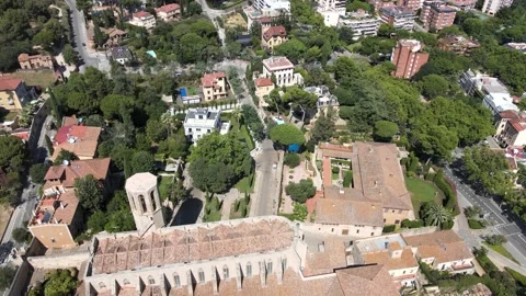 A camera drone flies backward above the Monastery of Pedralbes Stock Footage 202595400