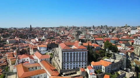A camera drone flies backward from the Episcopal Palace and Porto Cathedral Stock Footage 202061107