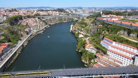 A camera drone flies backward over the Douro River, Porto Stock Footage 202060903