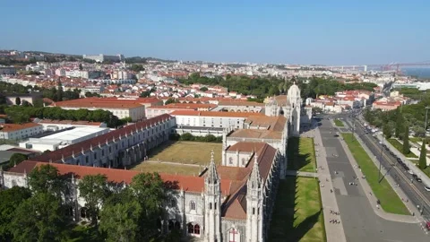 A camera drone flies forward above the Jerónimos Monastery and Maritime Museum Stock Footage 202012674