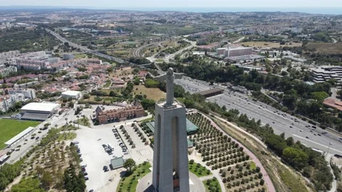 A camera drone flies forward above the Sanctuary of Christ the King in Lisbon Stock Footage 202016337