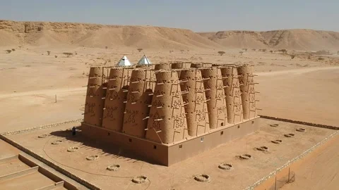 Camera drone flies out of the abandoned traditional mud brick Arab dovecote Stock Footage 153521929