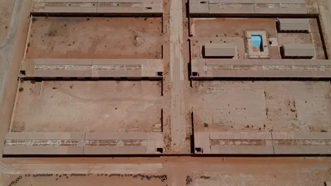 Camera drone flies over the abandoned camp in Khafs Daghrah Stock Footage 153521875