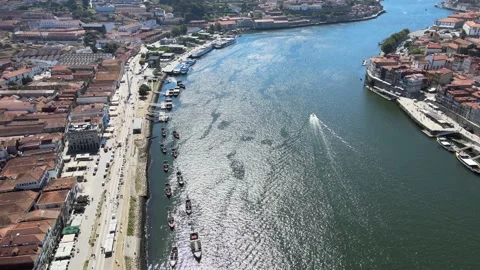 A camera drone flies over the left bank of the Douro River in Porto Stock Footage 202061055