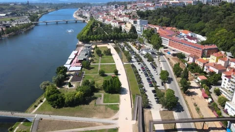 A camera drone flies over the right bank of Mondego River in Coimbra Stock Footage 202025227