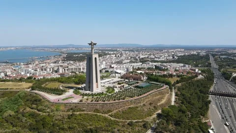 A camera drone flies towards the Sanctuary of Christ the King in Lisbon Stock Footage 202012919