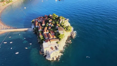 A camera drone flying around and above St. Stefan Island Stock Footage 249420784