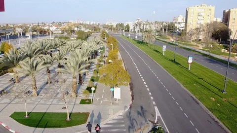 Camera on drone follows a group of runners on a bike path Stock Footage 125210201