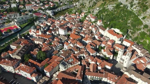 A camera drone orbiting above Kotor Old Town Stock Footage 249421265