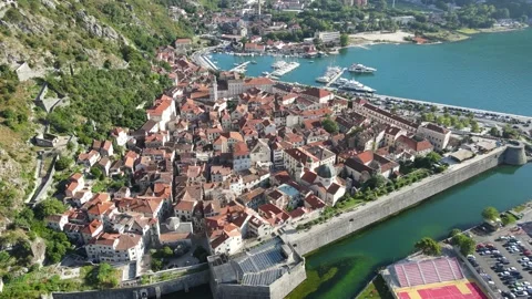 A camera drone orbiting above Kotor Old Town Stock Footage 249421495