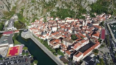 A camera drone orbiting above Kotor Old Town Stock Footage 249421655