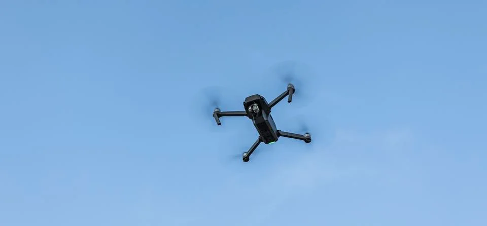 Camera drone wireless object flying in blue sky empty background copy space Stock Photos