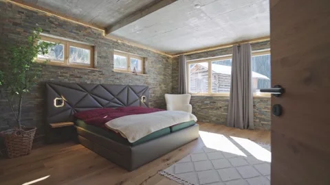 Camera entering a modern and cozy bedroom in a rustic mountain lodge with a view Stock-Footage 335198836