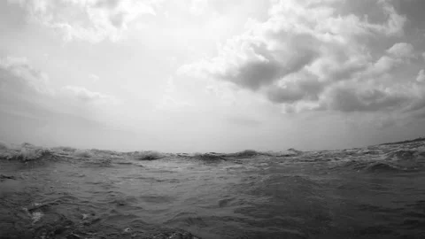 The camera enters the incoming wave with bubbles with sound Stock Footage 86699010