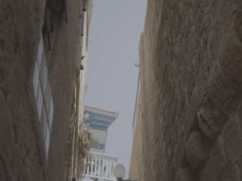 The camera faces up and moves through an narrow alley in the Old City, Jaffa LOG Video stock 83781693