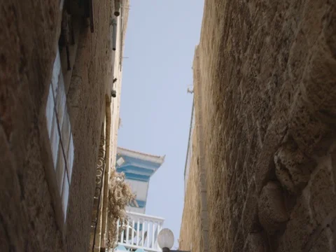 The camera faces up and moves through an narrow alley in the Old City, Jaffa Video stock 83782977
