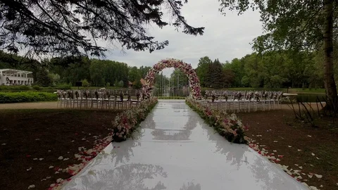 Camera fast flying above  wedding arch of flowers and the interior Stock Footage 128566371