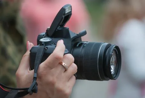 Camera in a female hand Stock Photos