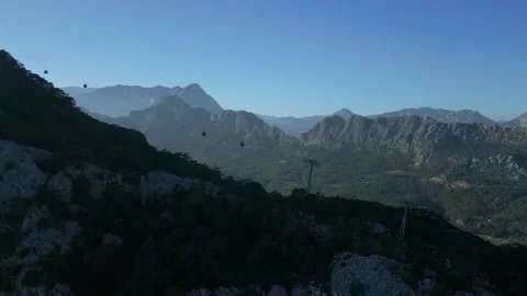 The camera files up to the side of the cable car and flies post passing Stock Footage 229324344