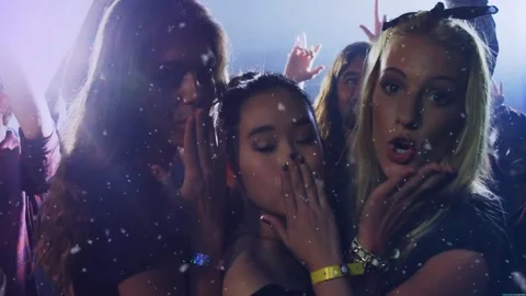 Camera filming 3 women posing and blowing kisses for crowd at concert stage Stock Footage 329899562