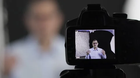 Camera, filming and live streaming with man in studio Stockbeeldmateriaal 332678092
