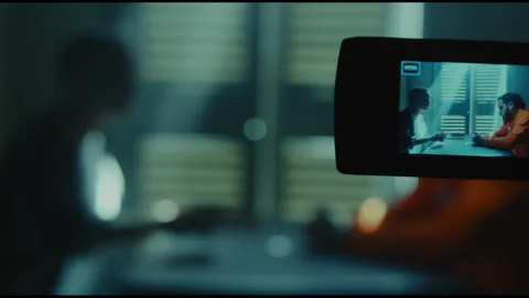 Camera filming a conversation between investigator and prisoner Stock Footage 275085212