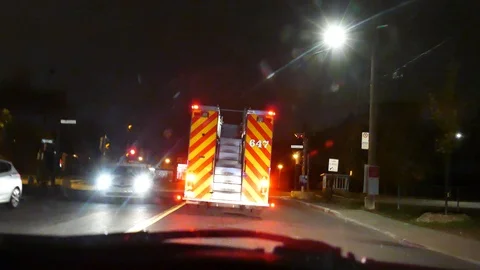 Camera filming firetruck falling from a car Stock Footage 120162627