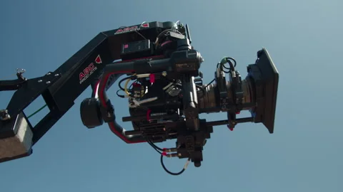 Camera fixed on elevated crane rises into glowing azure sky Stock Footage 321946553