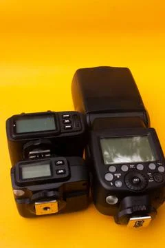 Camera flash on yellow background Stock Photos