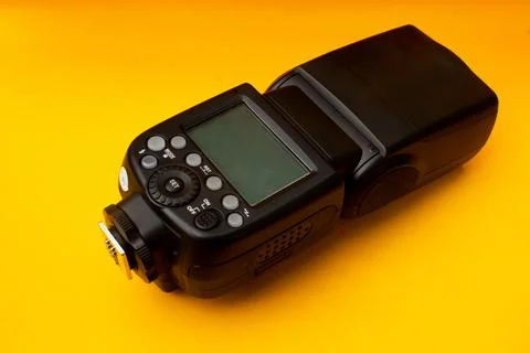 Camera flash on yellow background Stock Photos