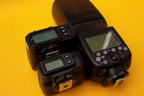 Camera flash on yellow background Stock Photos